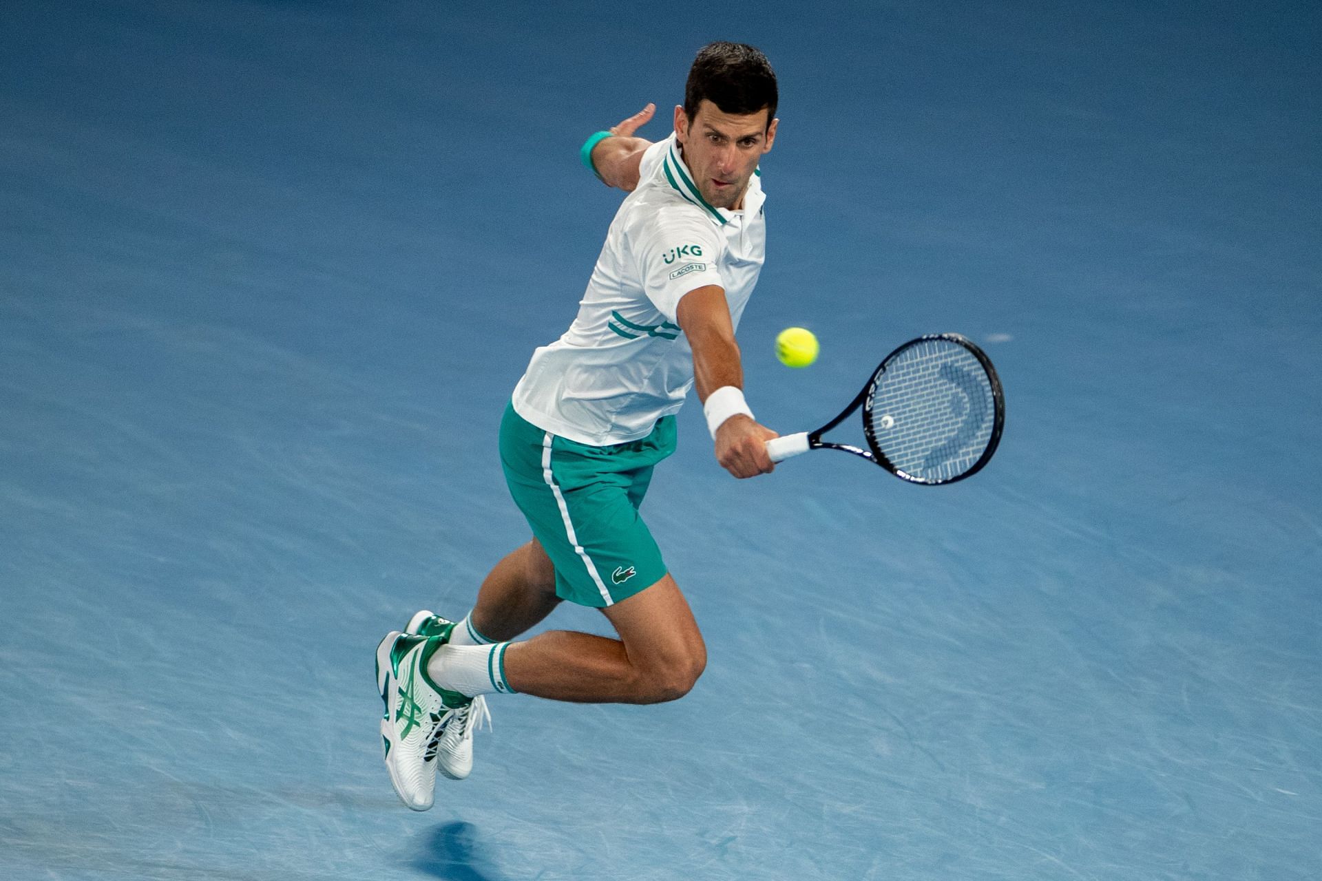 Novak Djokovic retrieves a ball at the 2021 Australian Open