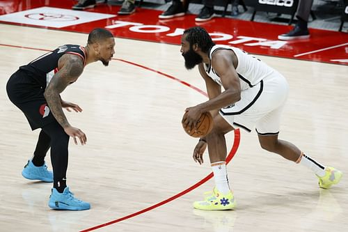 Damian Lillard of the Portland Trail Blazers guards James Harden of the Brooklyn Nets