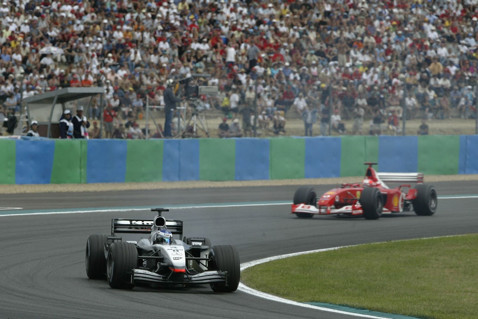 McLaren&#039;s Kimi Raikkonen pursued by Ferrari&#039;s Michael Schumacher at the Nevers Magny-Cours (Photo by Mark Thompson/Getty Images)