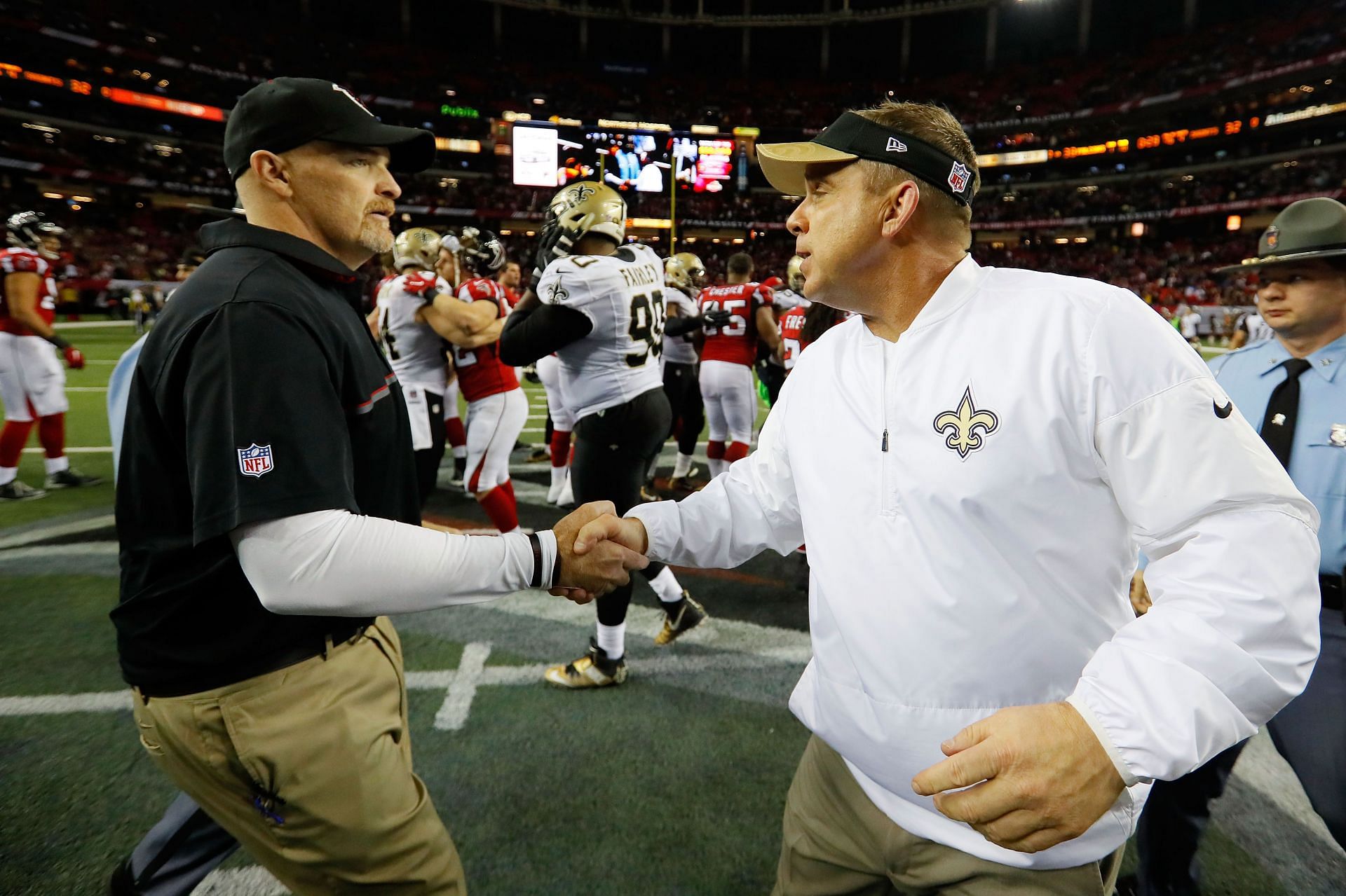 Old foe Dan Quinn (left, shaking hands with Sean Payton) is someone the Saints should probably avoid as they seek out a new head coach (Photo: Getty)