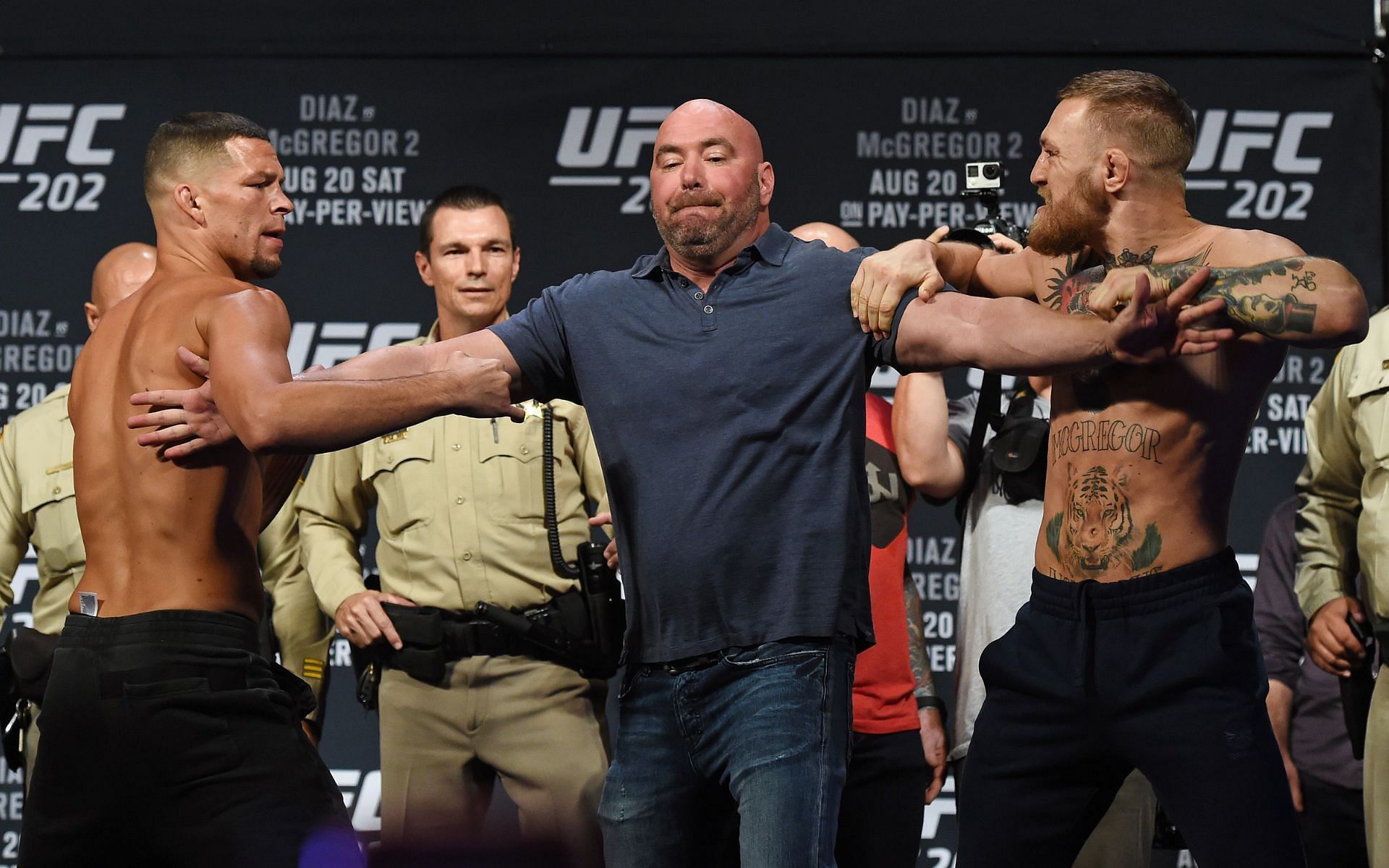 UFC president Dana White (center) separates Conor McGregor (right) and Nate Diaz (left) during the weigh-in ahead of their rematch