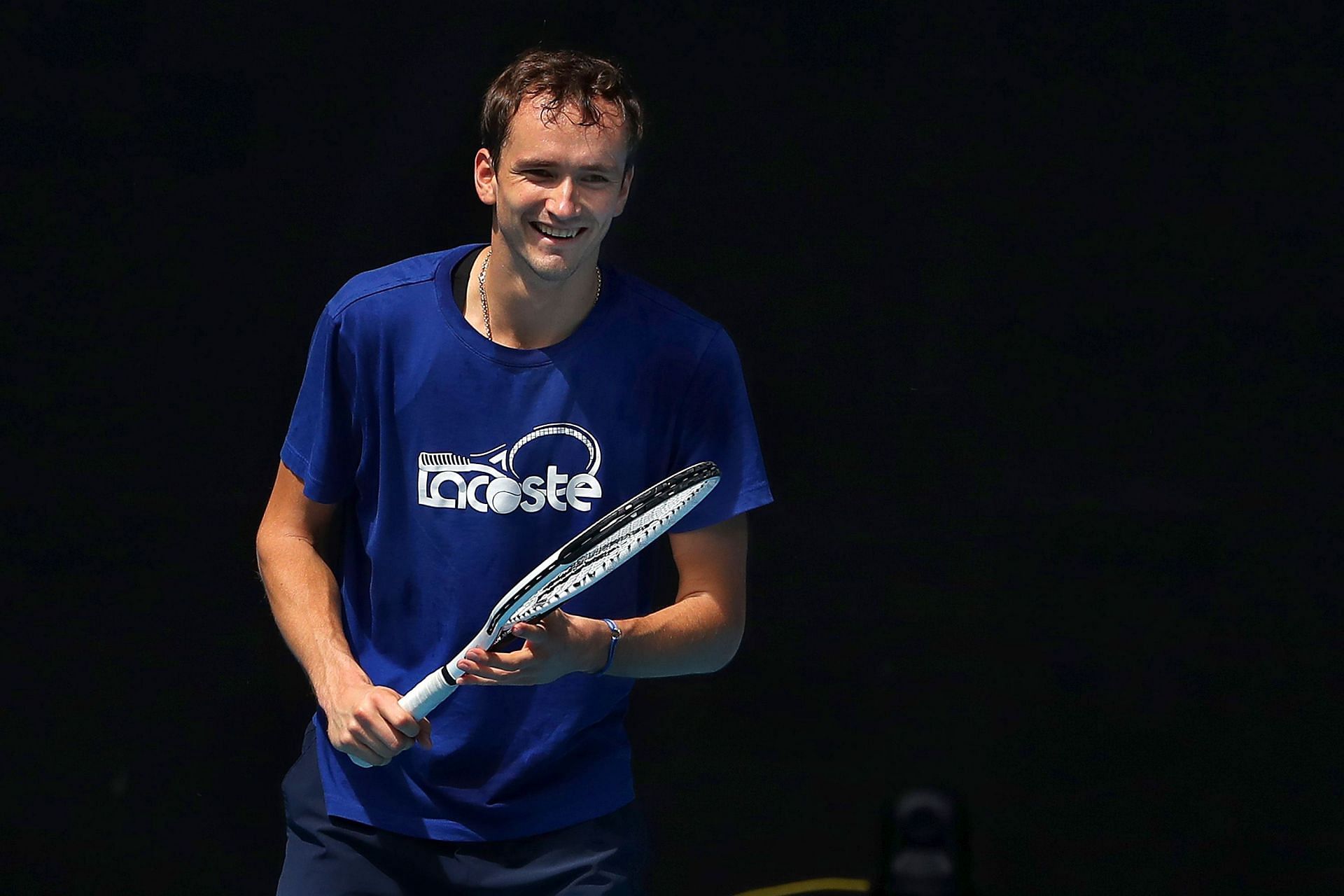 Daniil Medvedev smiles during a practice session ahead of the 2022 Australian Open
