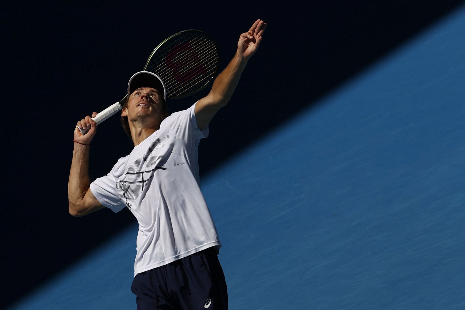 Alex de Minaur prepares to serve during a practice session