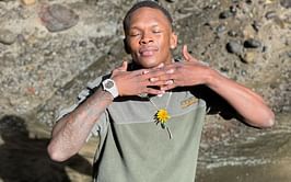 Hilarious responses ensue after Israel Adesanya asks fans to make memes out of his picture