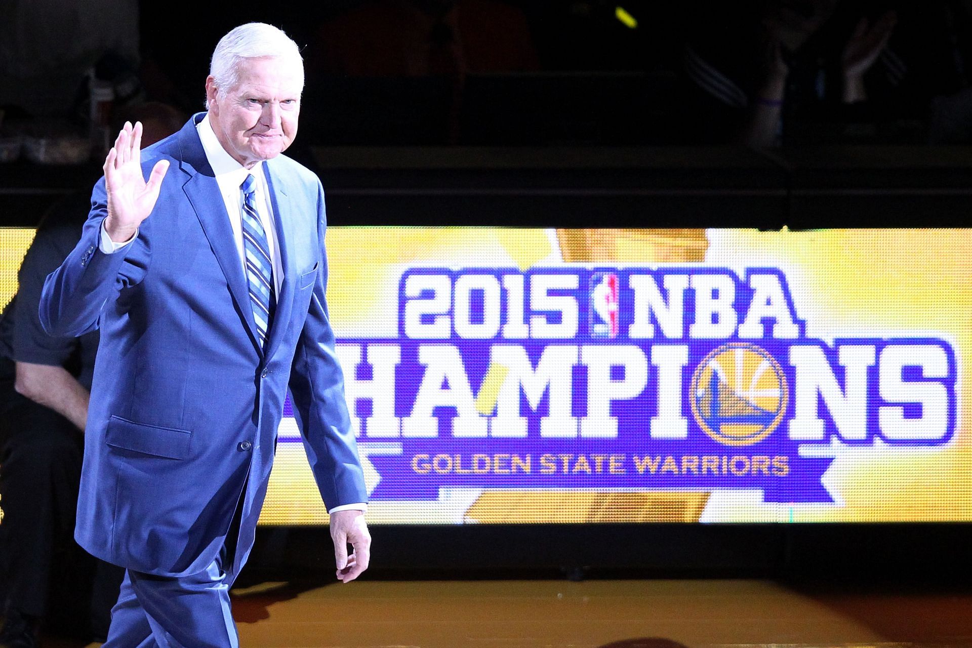 Executive Board Member Jerry West waves to the crowd during the ring ceremony for the 2015 Golden State Warriors championship season prior to the NBA season opener against the New Orleans Pelicans at ORACLE Arena on October 27, 2015 in Oakland, California.