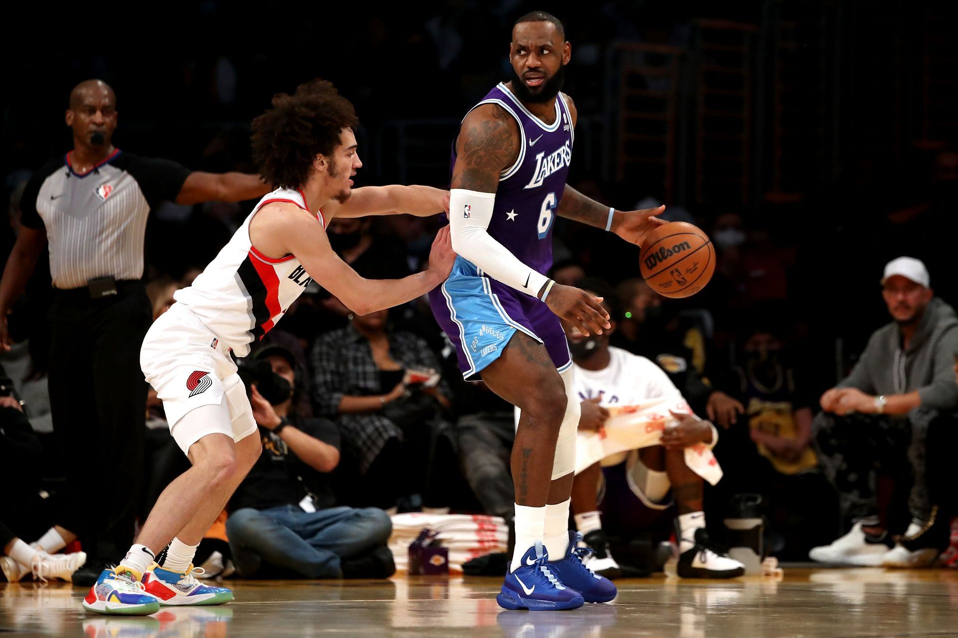 LeBron James of the LA Lakers handles the ball against CJ Elleby of the Portland Trail Blazers.