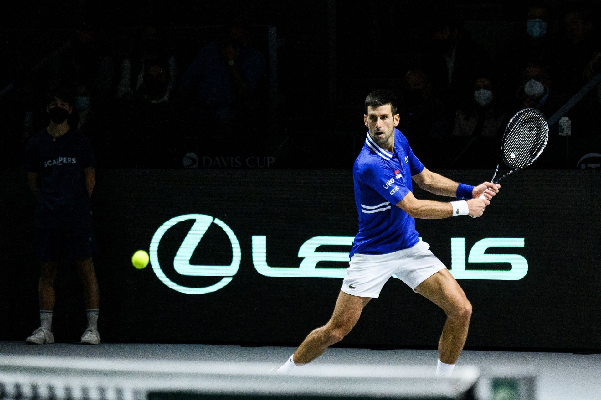 Novak Djokovic plays a backhand against Marin Cilic during a 2021 Davis Cup Semifinal match at Madrid Arena pavilion