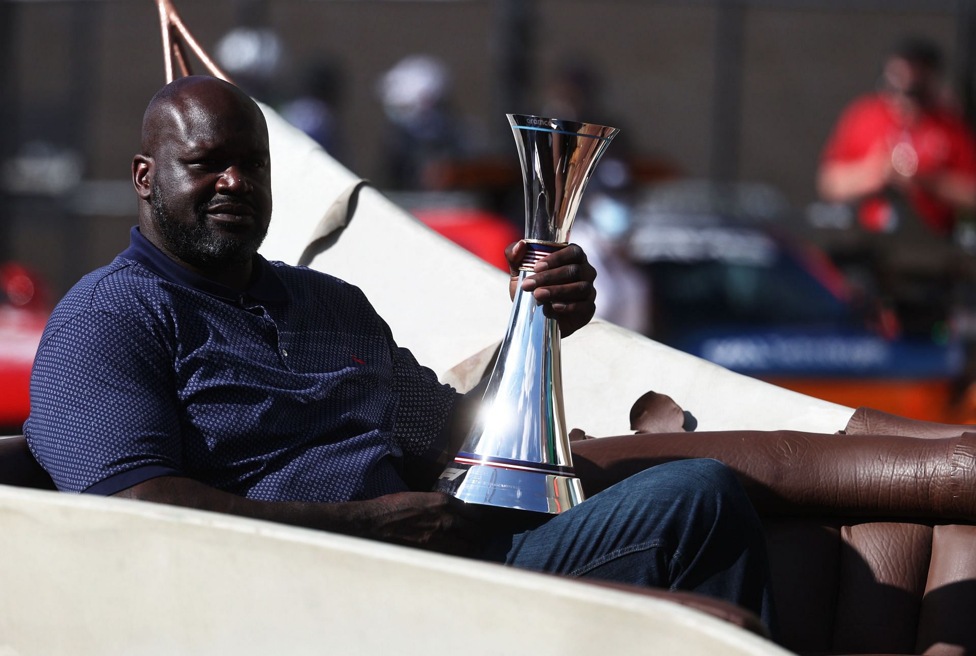 NBA legend Shaquille O&#039;Neal brings the race winners trophy to the podium during the F1 Grand Prix of USA at Circuit of The Americas on October 24, 2021 in Austin, Texas.