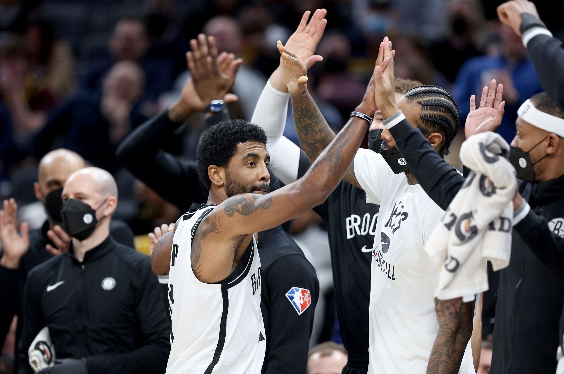 Kyrie Irving #11of the Brooklyn Nets celebrates with teammates as he leaves the game in the fourth quarter against the Indiana Pacers at Gainbridge Fieldhouse on January 05, 2022 in Indianapolis, Indiana.