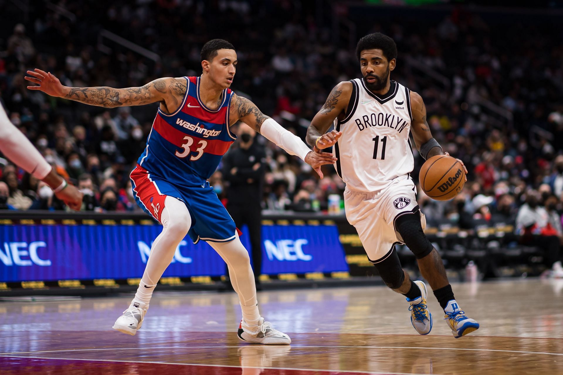 Kyle Kuzma guarding Kyrie Irving in a game between the Washington Wizards and the Brooklyn Nets