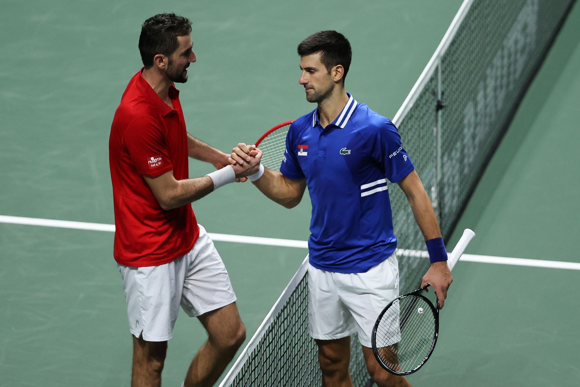 Marin Cilic and Novak Djokovic shake hands after their match at the Davis Cup Finals 2021