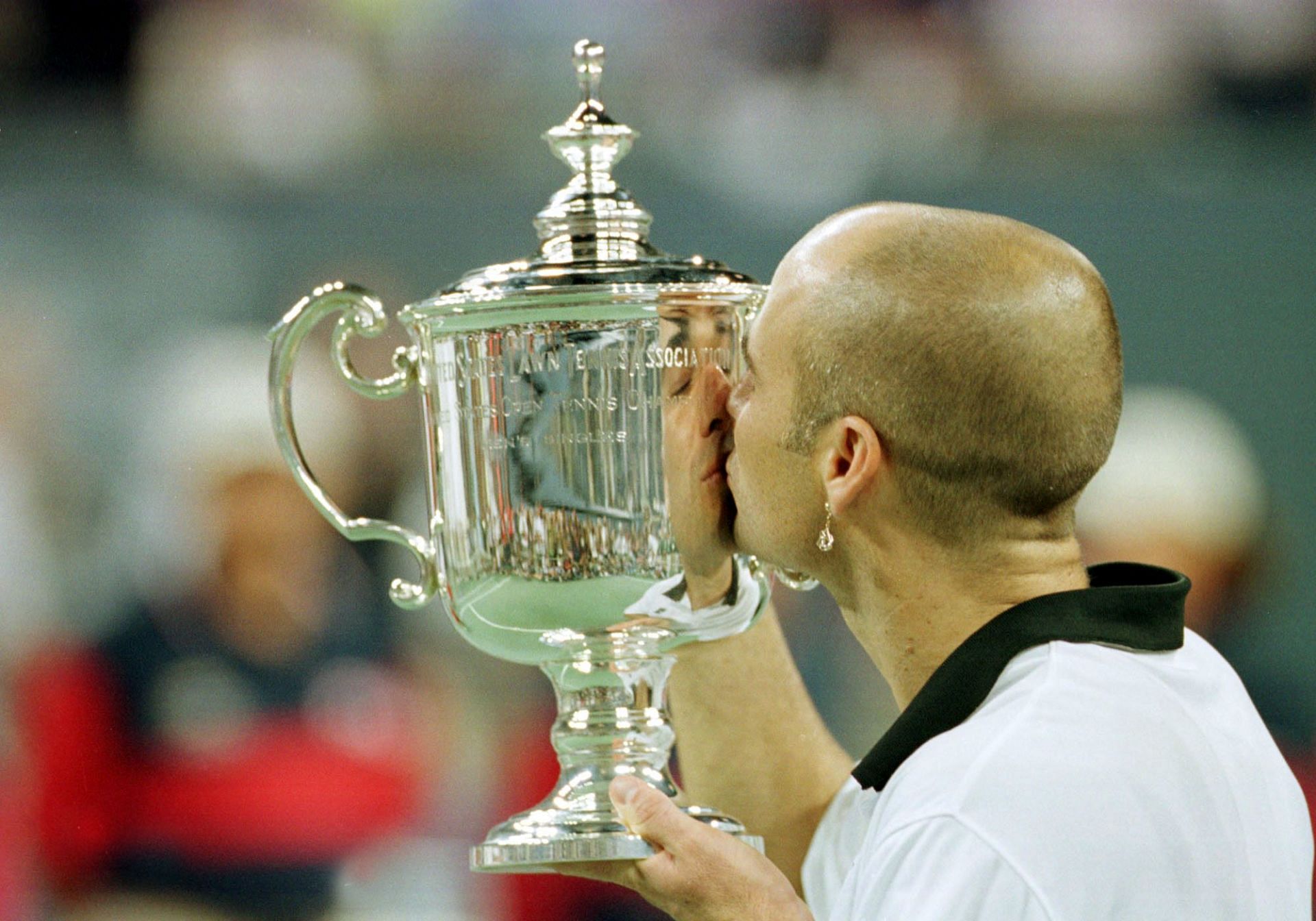 Andre Agassi kisses the winners trophy at the 1999 US Open
