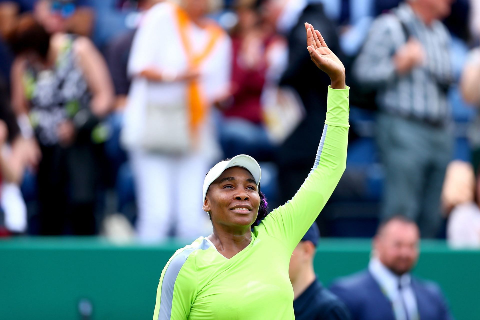 Venus Williams waves to the crowd at a tournament