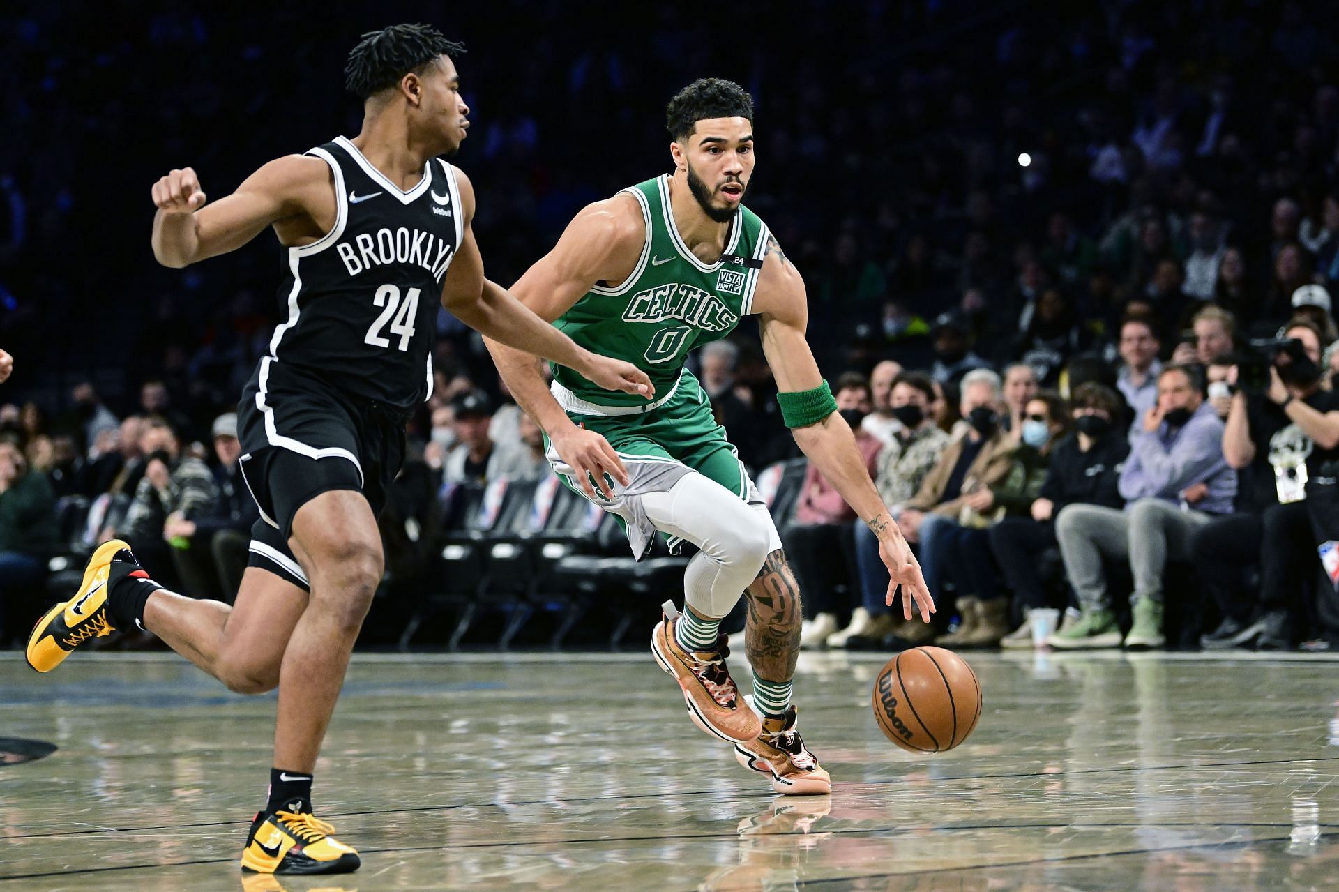 Jayson Tatum #0 of the Boston Celtics is defended by Cam Thomas #24 of the Brooklyn Nets