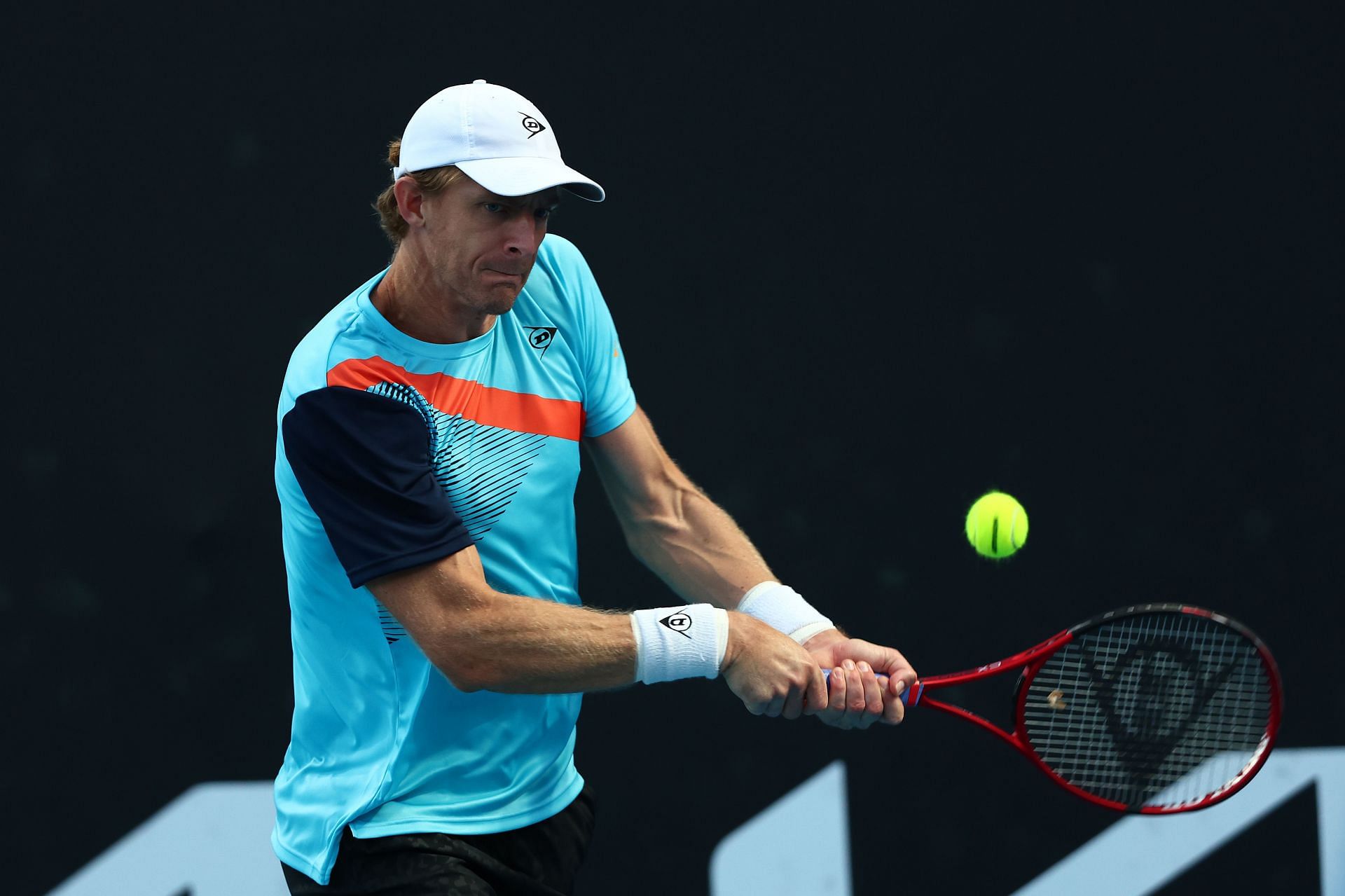 Kevin Anderson strikes a backhand at 2022 Australian Open.