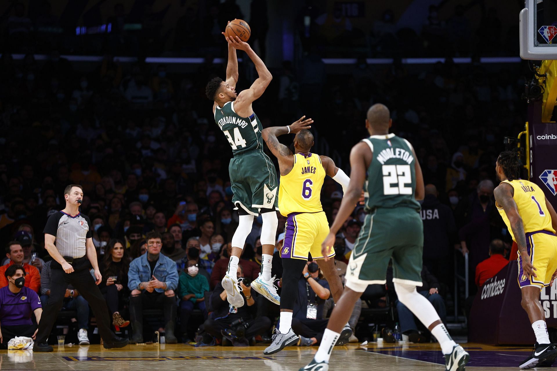 Giannis Antetokounmpo attempts a tough shot over LeBron James.