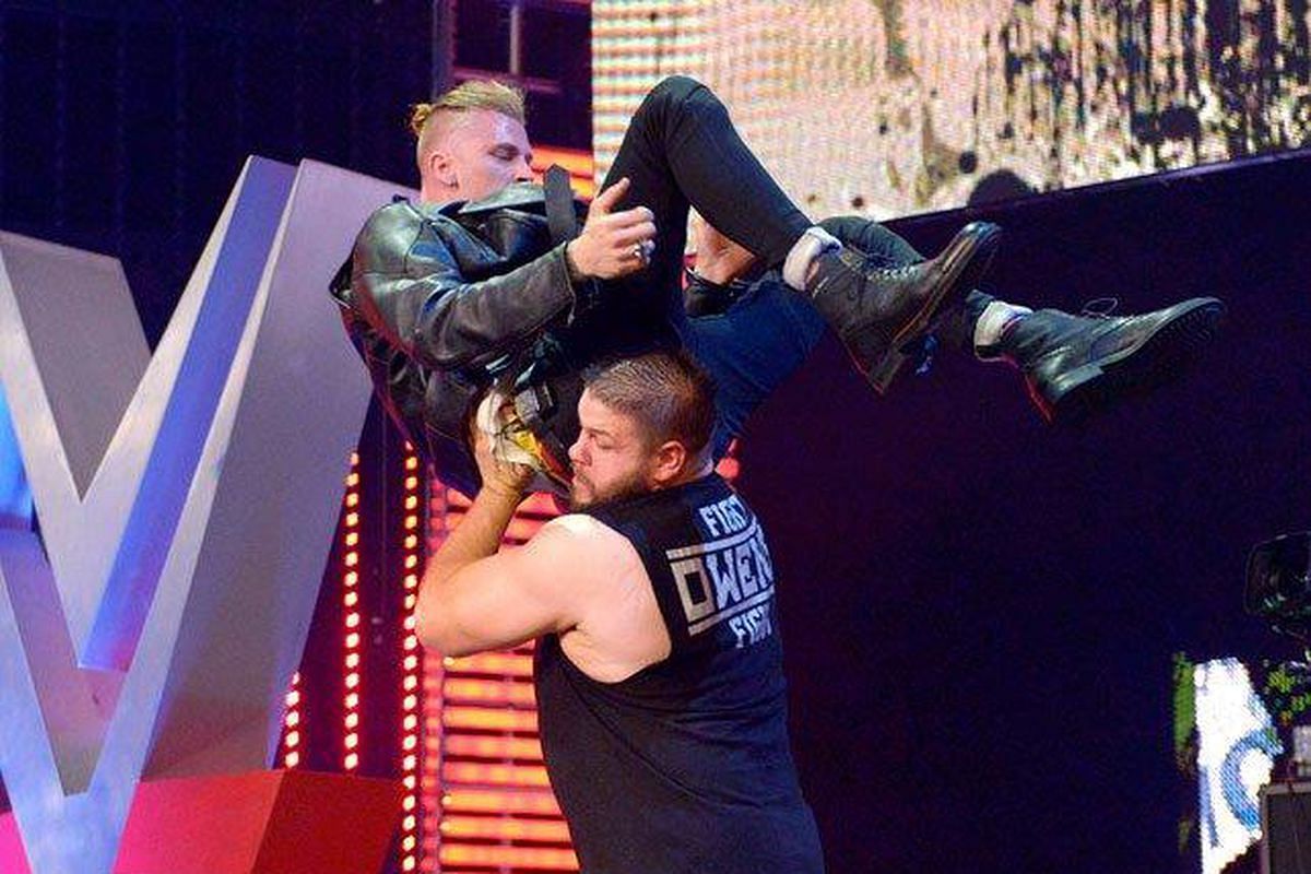 Machine Gun Kelly gets thrown from the WWE RAW stage by Kevin Owens in July 2015