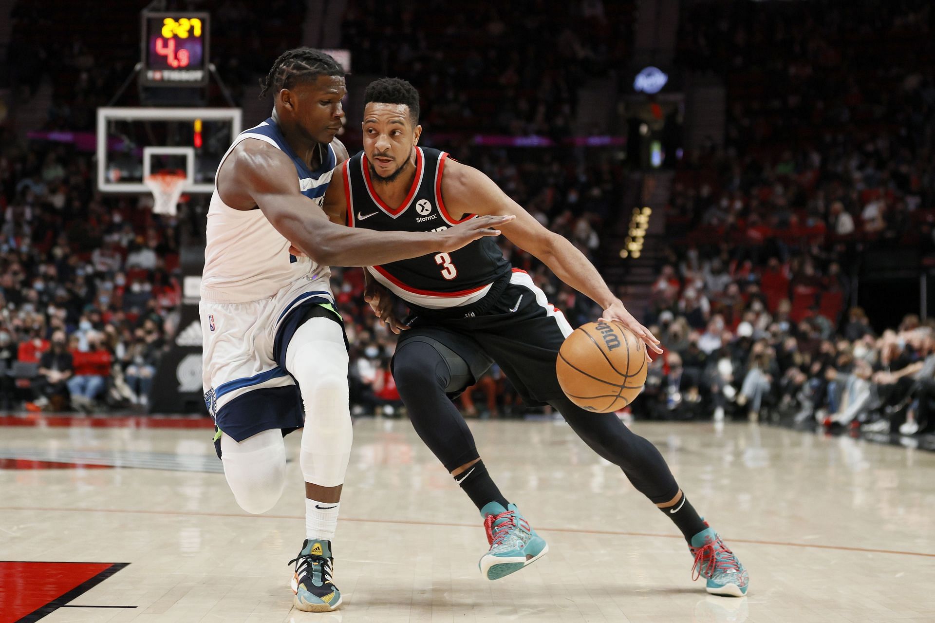 PORTLAND, OREGON - JANUARY 25: Anthony Edwards #1 of the Minnesota Timberwolves defends CJ McCollum #3 of the Portland Trail Blazers during the first quarterat Moda Center on January 25, 2022 in Portland, Oregon.