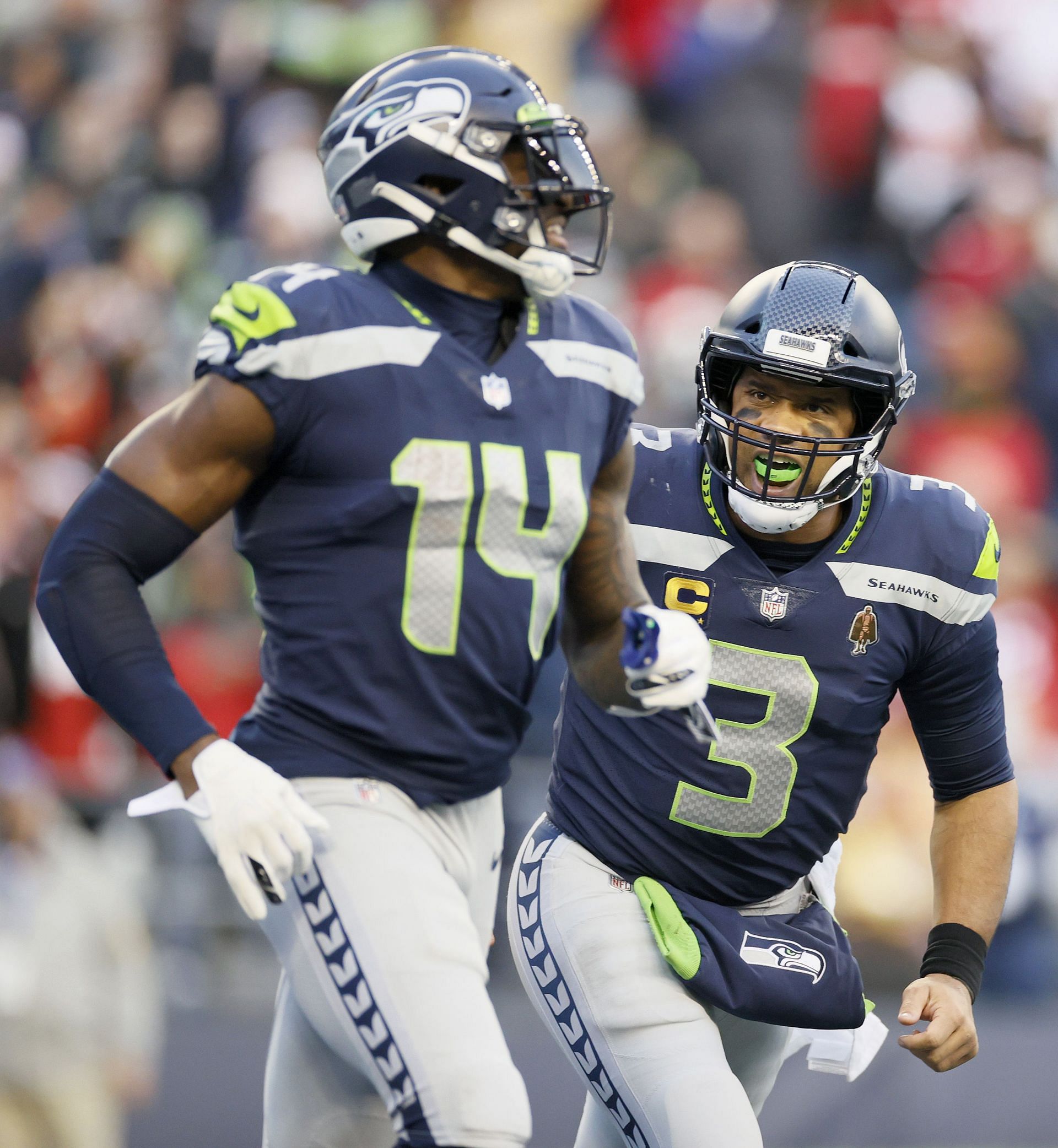 Seattle Seahawks quarterback Russell Wilson (3) greets wide receiver DK  Metcalf (14) during warmups before an NFL football game against the Tennessee  Titans, Sunday, Sept. 19, 2021, in Seattle. (AP Photo/John Froschauer