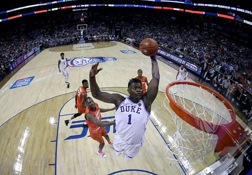 Zion Williamson attempts to dunk the ball during a college game.