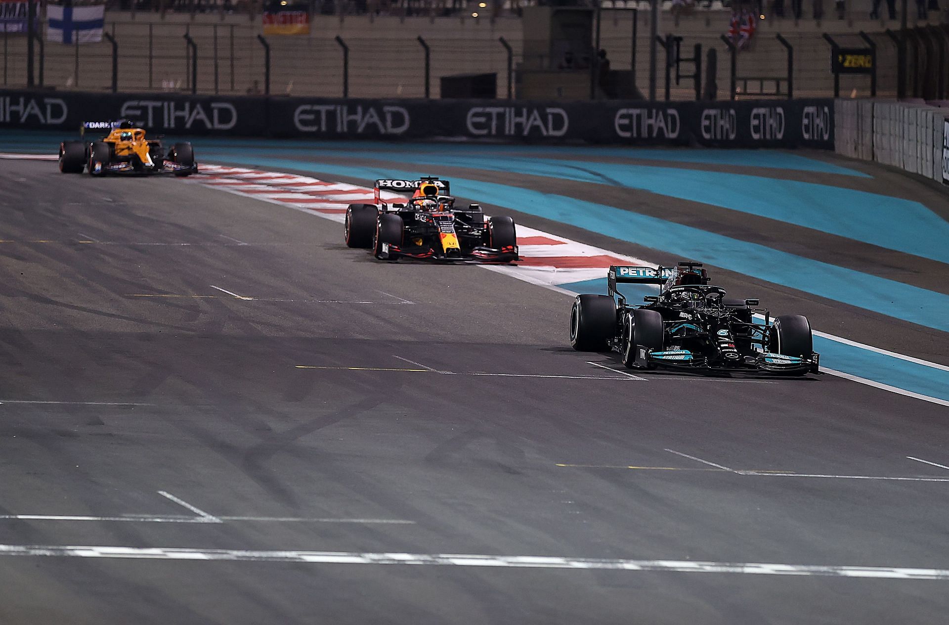 Lewis Hamilton (#44) Mercedes-AMG Petronas W12 leads Max Verstappen (#33) Red Bull Racing Honda RB16B, on lap 58 of the 2021 Abu Dhabi Grand Prix
