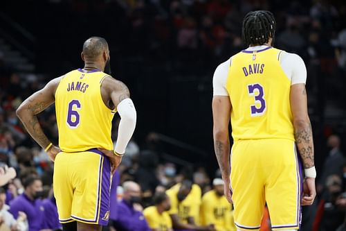 LeBron James and Anthony Davis of the LA Lakers watch a foul shot by the Portland Trail Blazers during the first quarter Feb. 9, 2022 in Portland, Oregon.