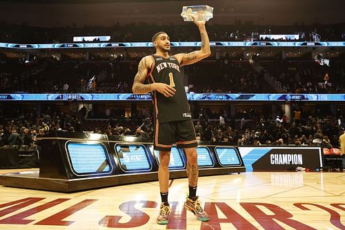 Obi Toppin of the New York Knicks holds up the trophy after winning the Dunk Contest