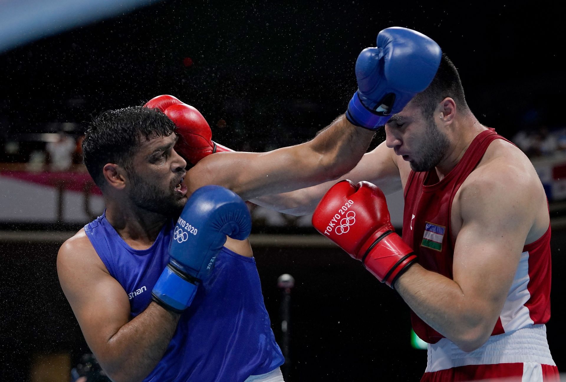 An Indian boxer (L) in action at Tokyo Olympics