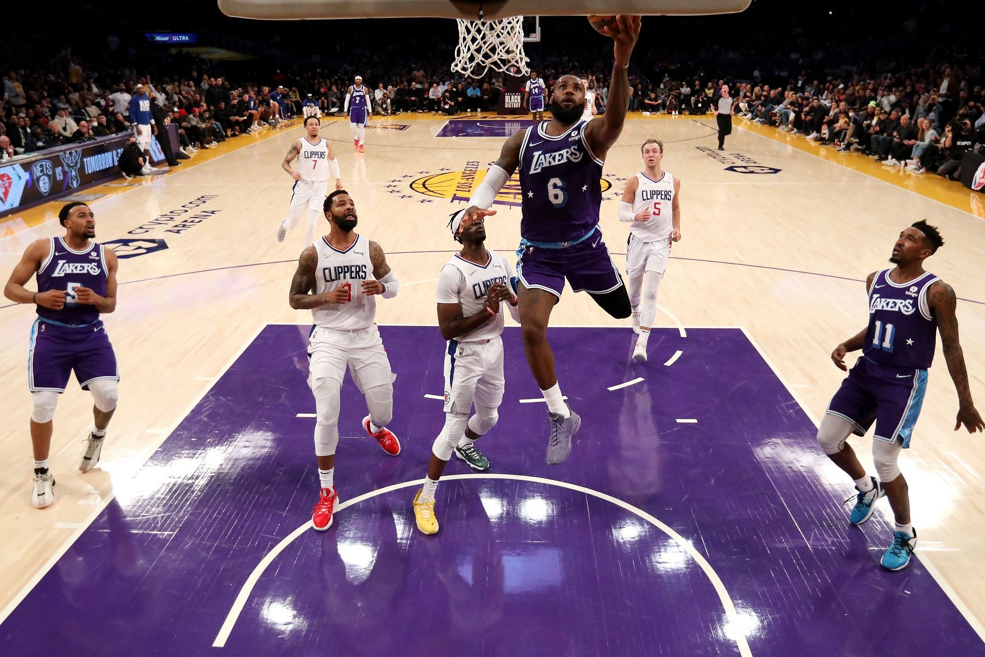 LeBron James #6 of the Los Angeles Lakers drives to the basket against Marcus Morris Sr. #8 and Reggie Jackson #1 of the Los Angeles Clippers