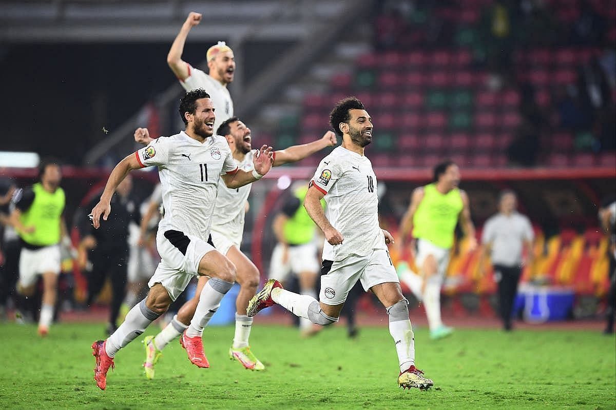 Egyptian players celebrate after winning the semi-final against Cameroon on penalties