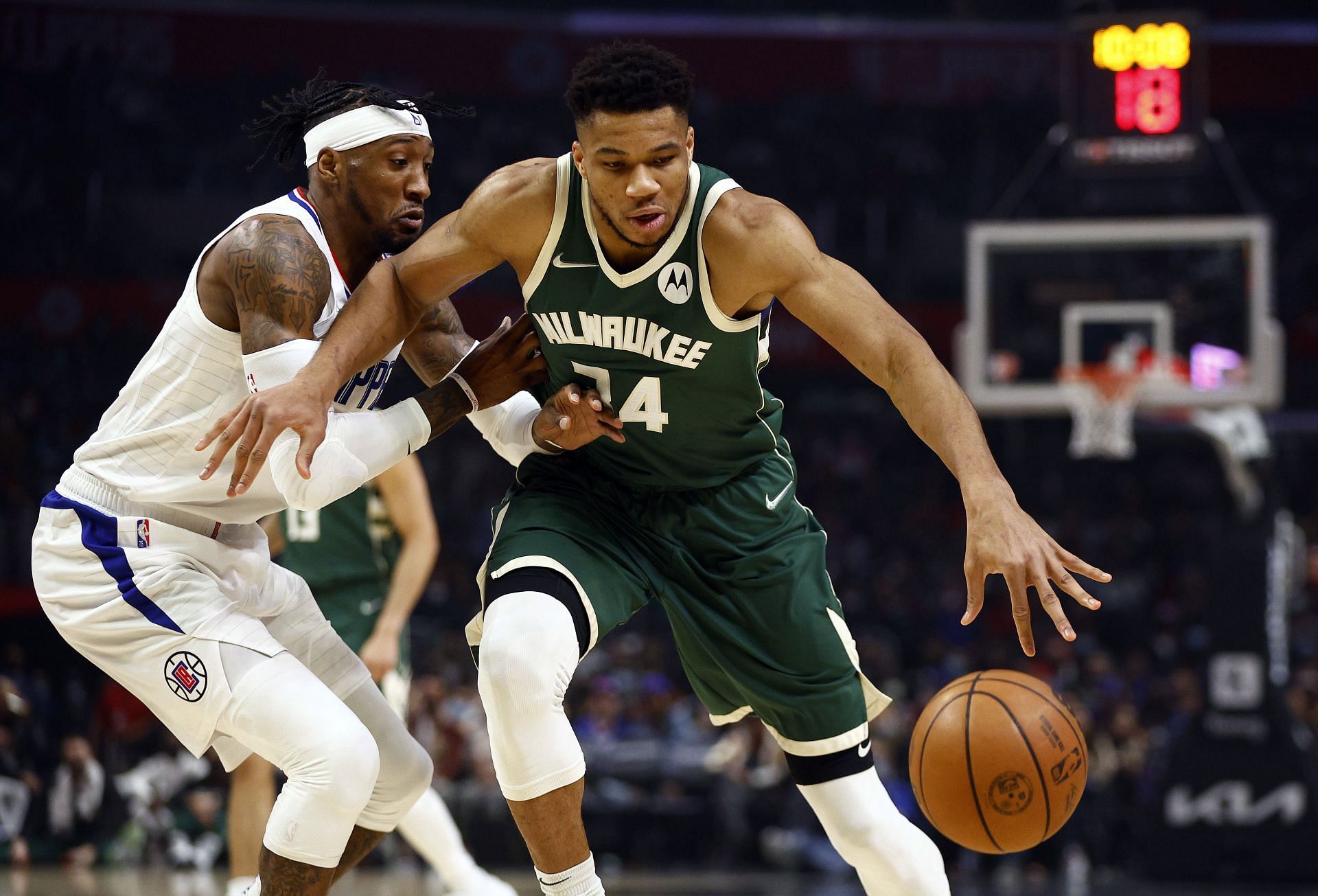 Giannis Antetokounmpo attempts to drive past Robert Covington