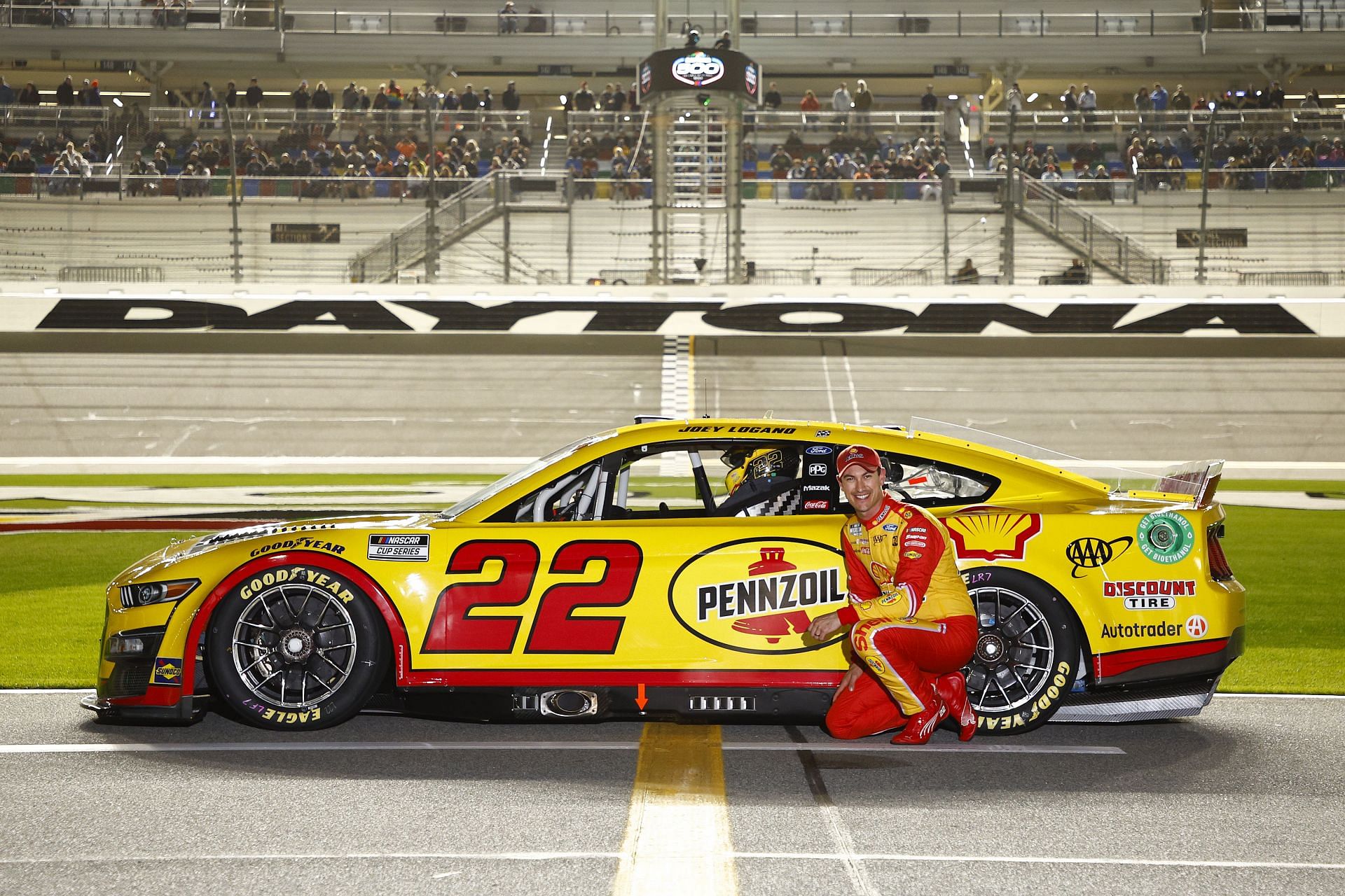Joey Logano poses with his #22 car before the NASCAR Cup Series 64th Annual Daytona 500 Qualifying