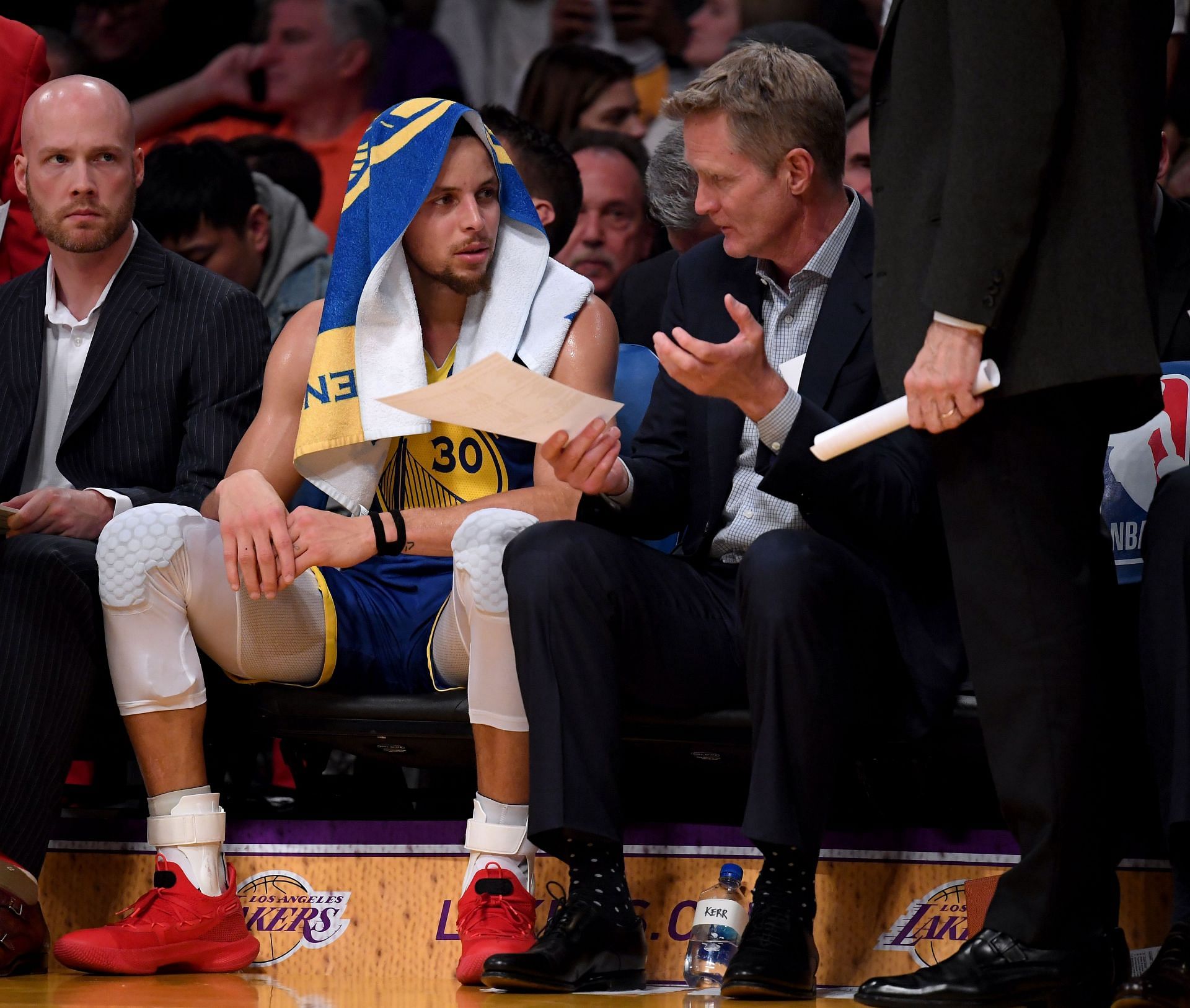 Steve Kerr and Steph Curry discussing in a game for the Golden State Warriors