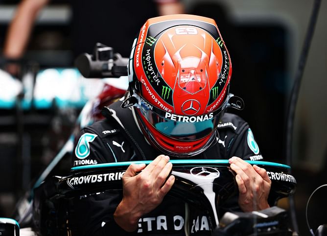 Lewis Hamilton watches on as George Russell sits in Mercedes W13 for first time