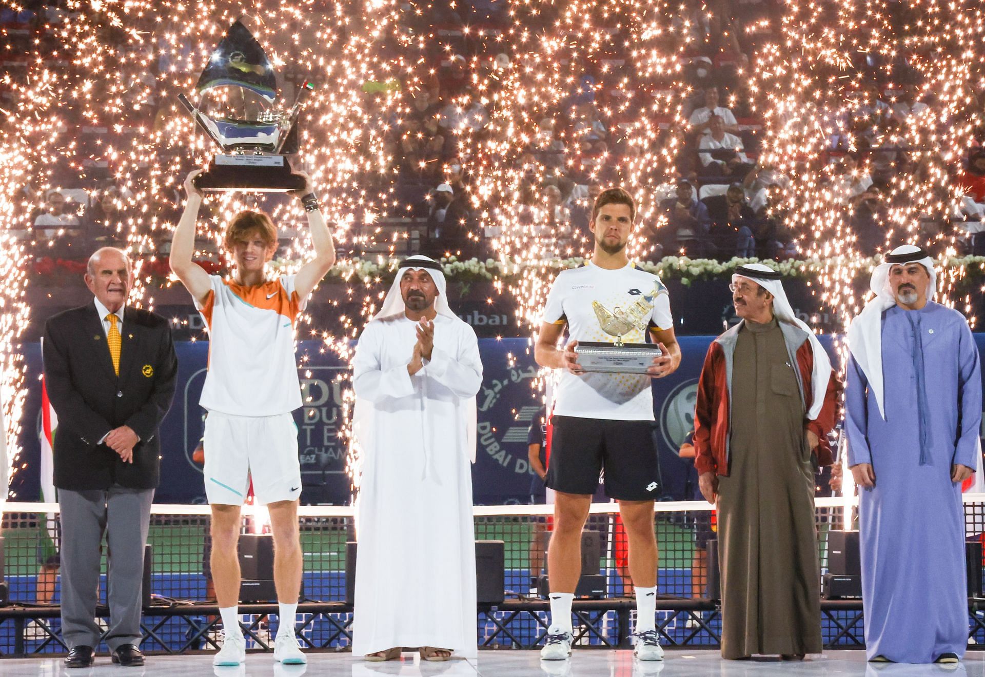 Andrey Rublev (2nd L) holds the trophy next to Jiri Vesely (3rd L) at the Dubai Tennis Championships.