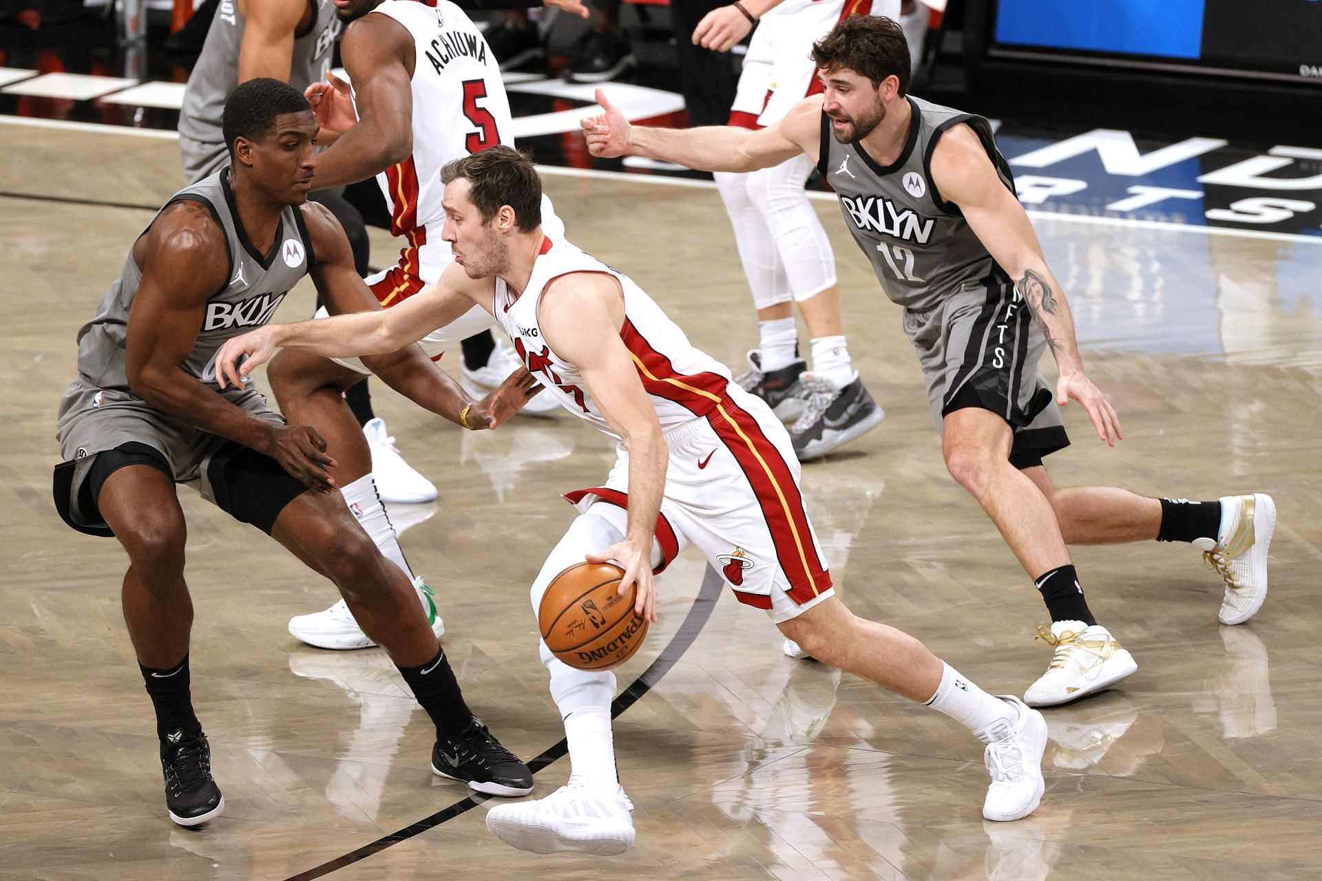 Goran Dragic of the Miami Heat dribbles against Reggie Perry and Joe Harris (12) of the Brooklyn Nets during the second half at Barclays Center on Jan. 25, 2021, in New York City. The Nets won 98-85.