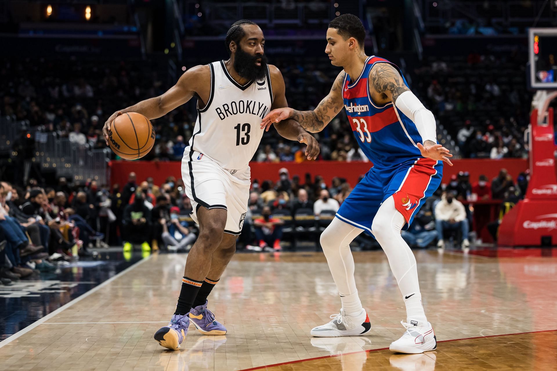 James Harden of the Brooklyn Nets handles the ball against Kyle Kuzma of the Washington Wizards.