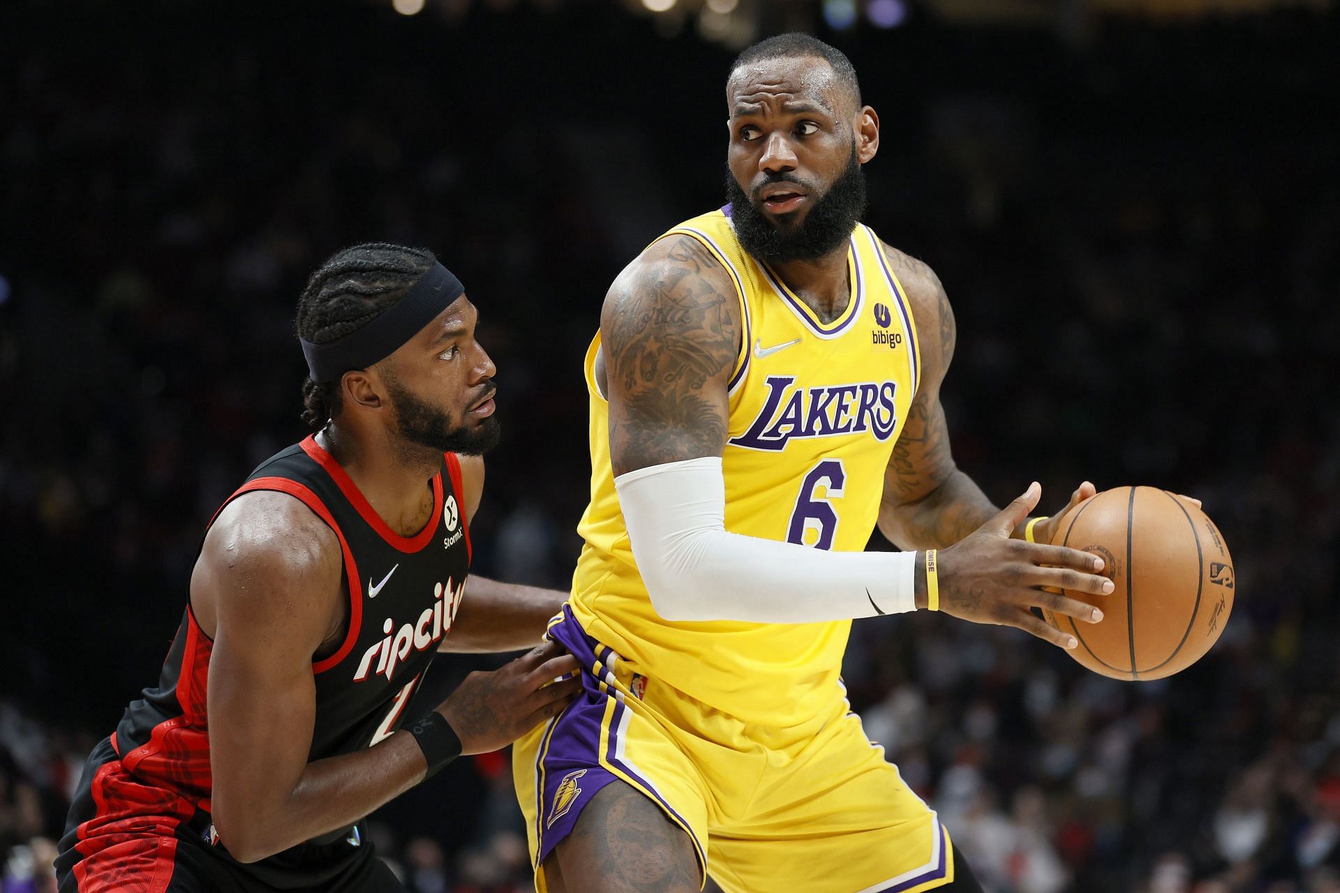 LeBron James #6 of the Los Angeles Lakers dribbles against Justise Winslow #26 of the Portland Trail Blazers