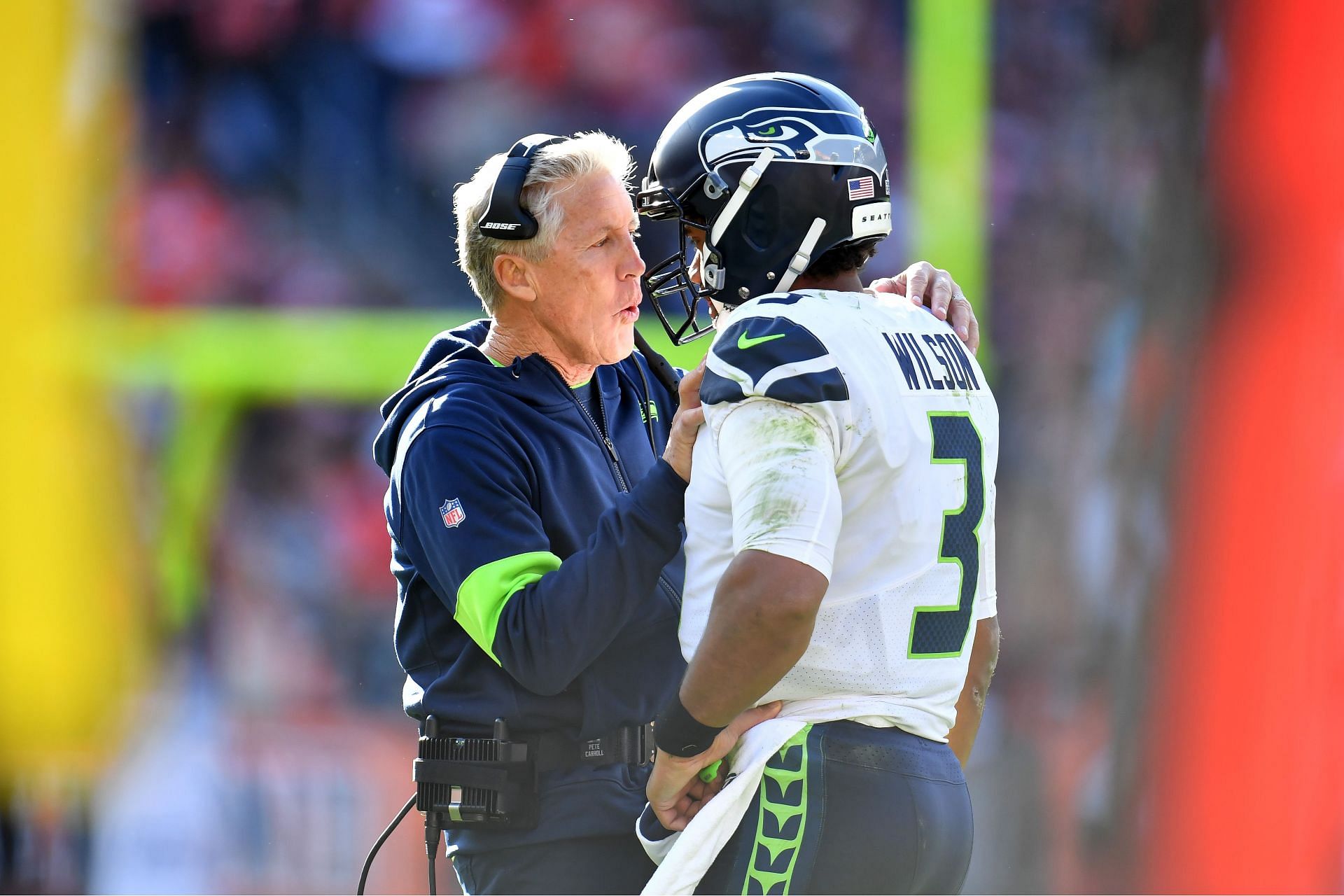 Pete Carroll and Russell Wilson talking on the sidelines