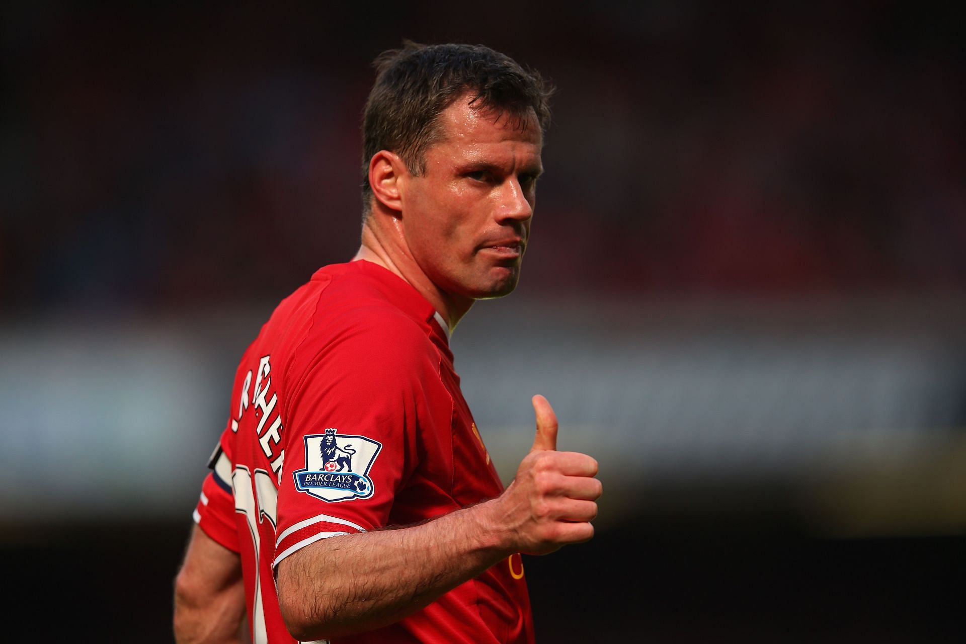 Carragher giving a thumbs up to the Liverpool fans