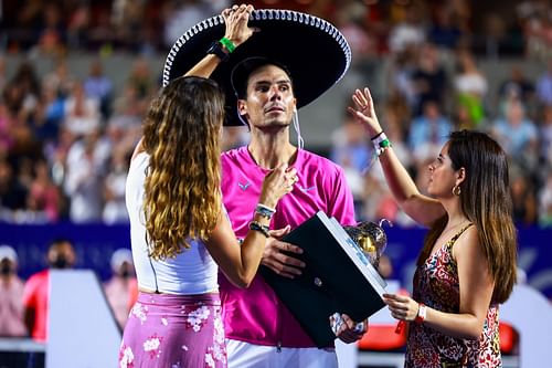 The 21-time Major winner poses with the Mexican Open trophy.