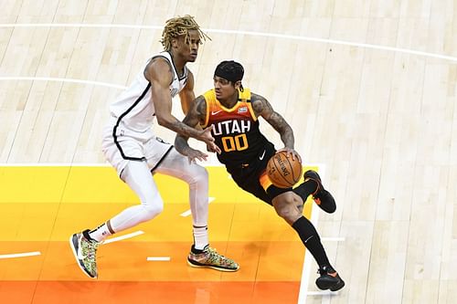 Jordan Clarkson of the Utah Jazz drives past Nicolas Claxton of the Brooklyn Nets