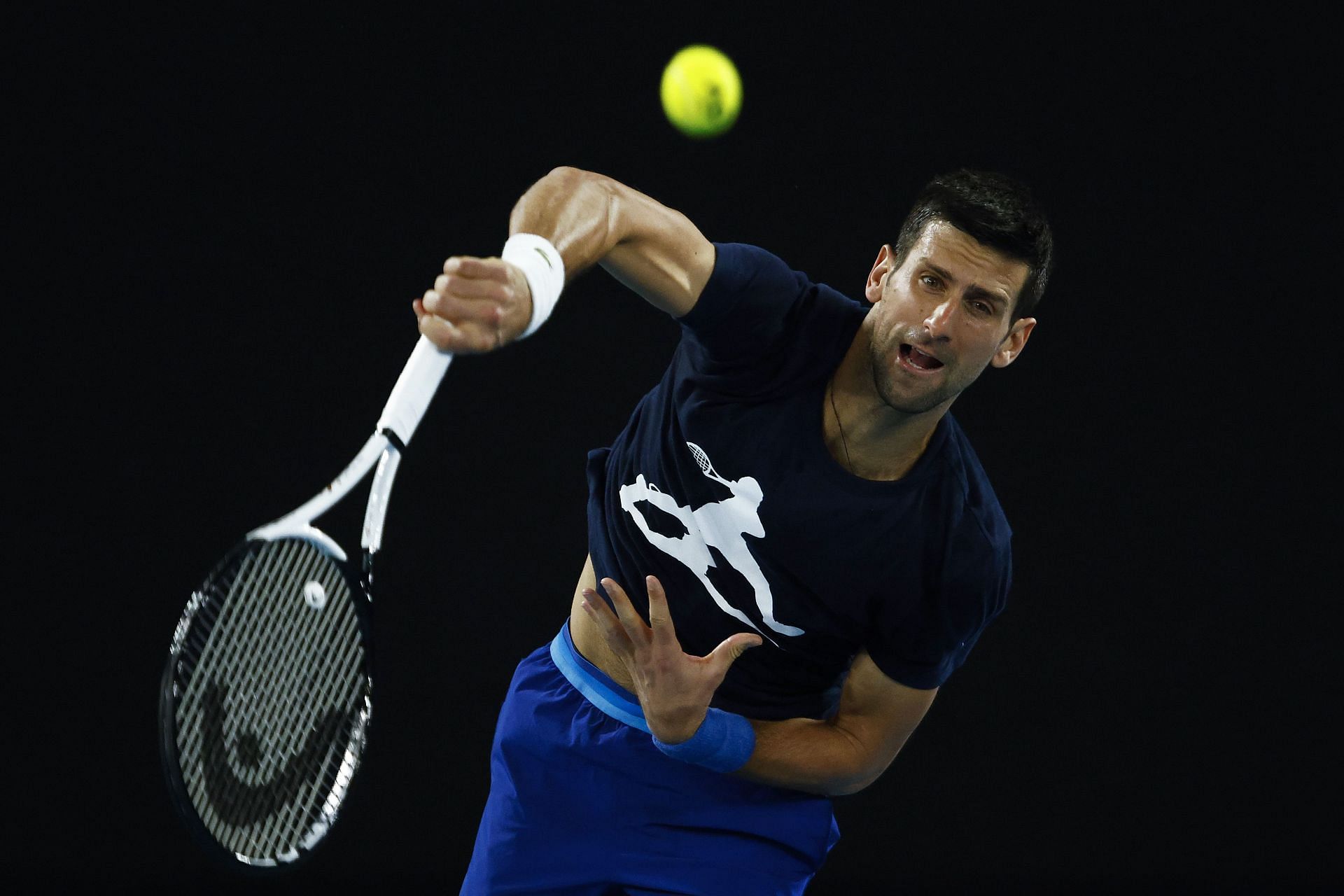 Novak Djokovic serves in pracice prior to the 2022 Australian Open