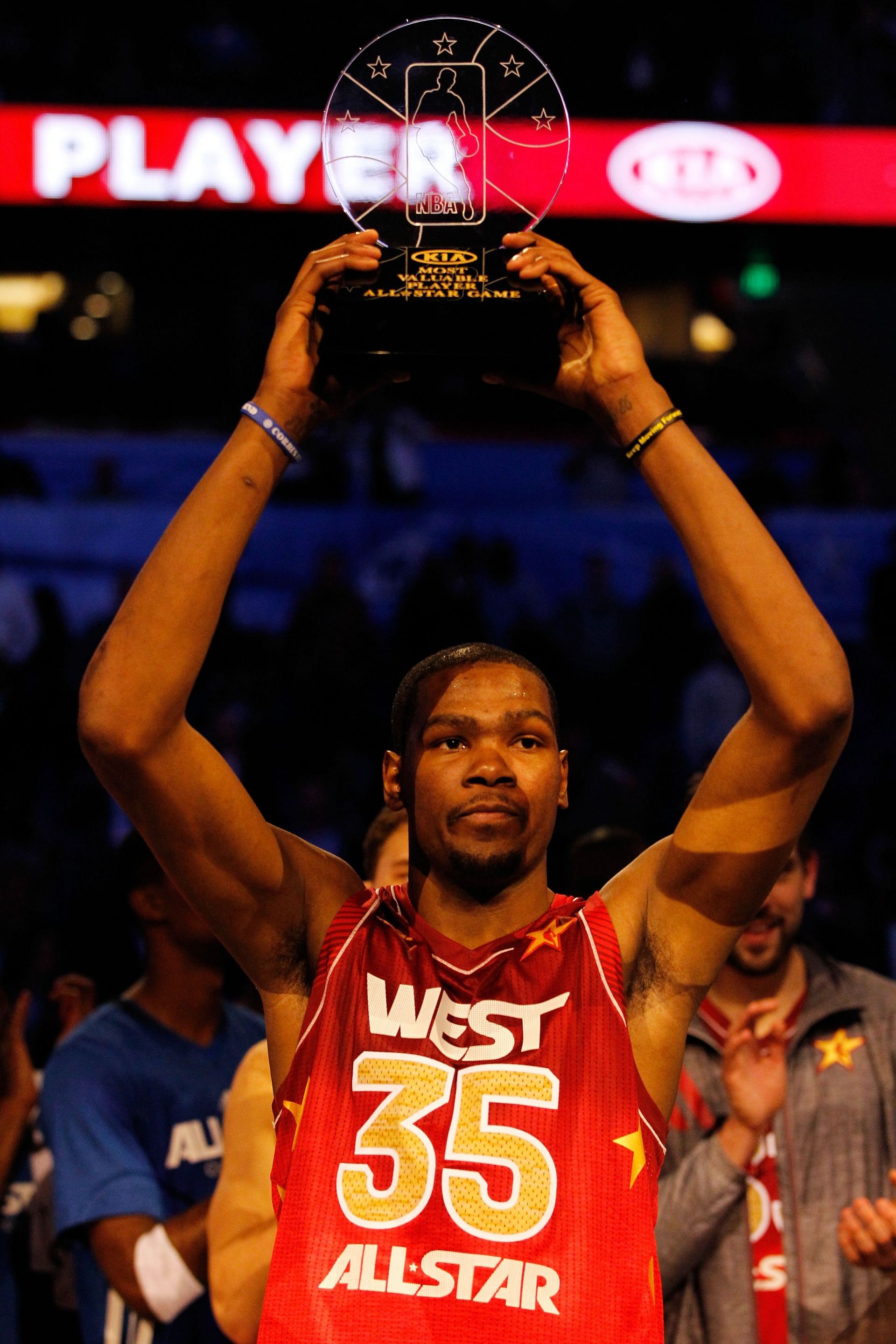 Kevin Durant #35 of the Oklahoma City Thunder and the Western Conference holds up the MVP trophy