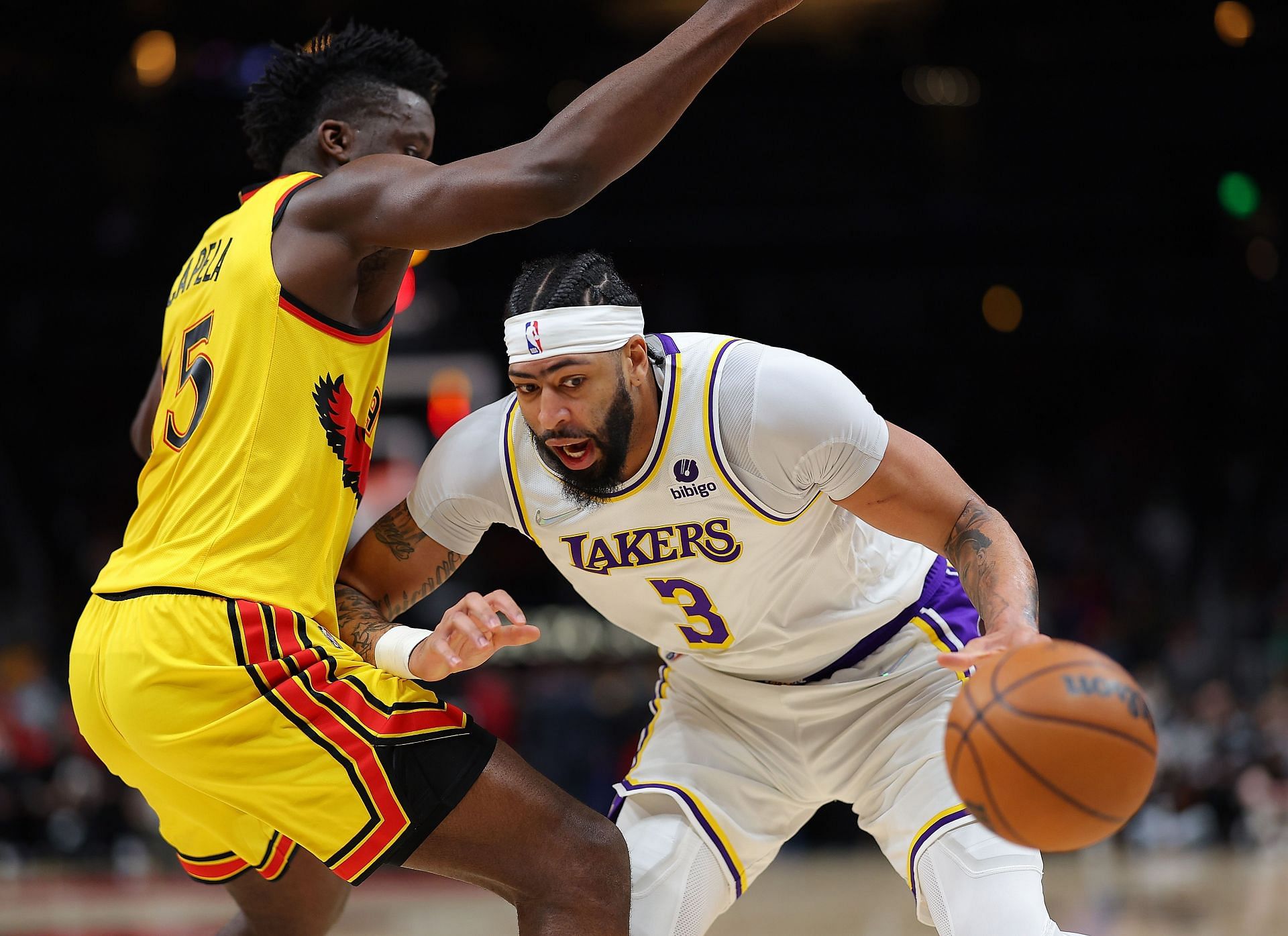 Anthony Davis of the LA Lakers turns over the ball as he is charged with traveling while driving into Clint Capela of the Atlanta Hawks on Jan. 30, 2022, in Atlanta, Georgia.