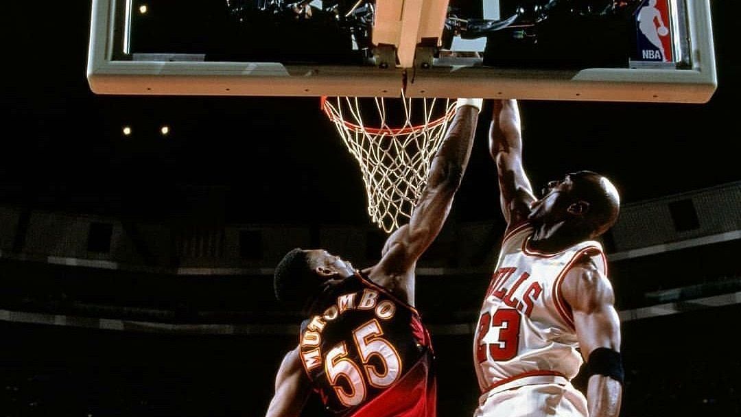Michael Jordan dunking on Dikembe Mutombo. (Photo: Courtesy of NBA.com)