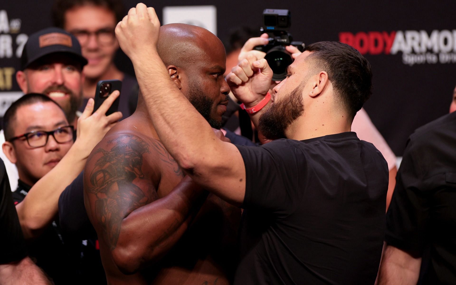 Derrick Lewis (left) and Tai Tuivasa (right) face off after their UFC 271 ceremonial weigh-ins in Houston on Friday