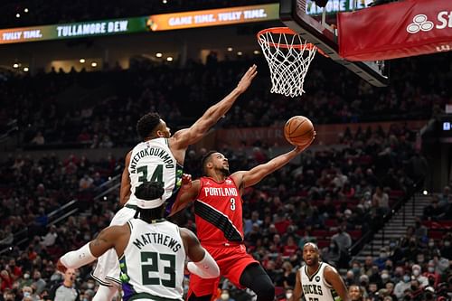 Milwaukee Bucks v Portland Trail Blazers; CJ McCollum drives against Giannis Antetokoumpo