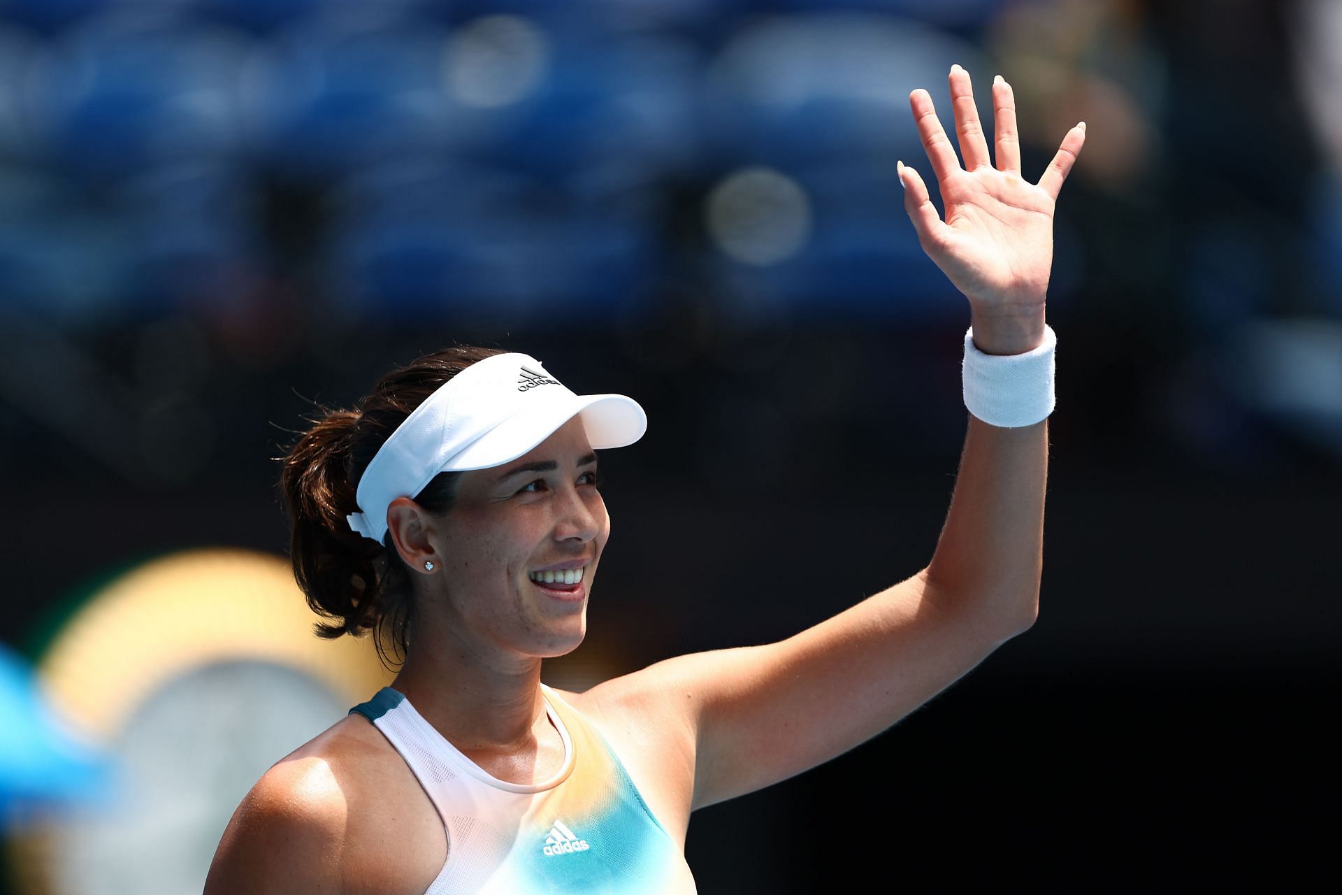 Garbine Muguruza waves to the crowd after a win at 2022 Australian Open.