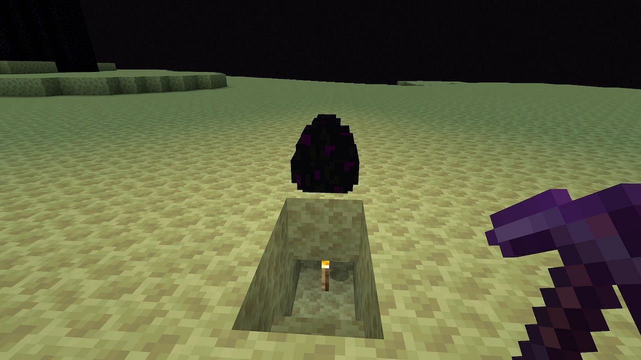 Players can also use the torch method to break the dragon egg and collect it that way (Image via Minecraft)